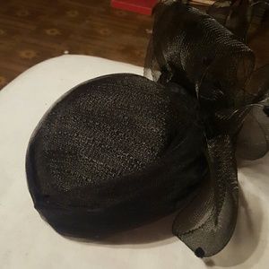 A black little hat with black mesh